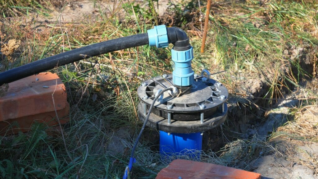An air compressor actively pumping air into a newly constructed water bore, facilitating the process of cleaning and filtering the water within the well.