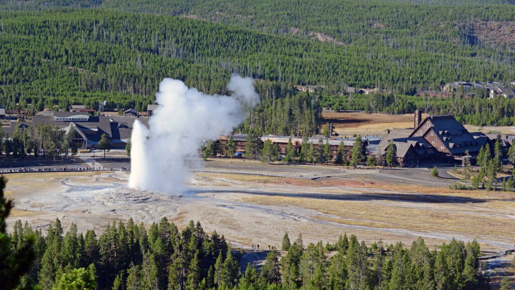 Geothermal energy plant and natural landscape, highlighting renewable power benefits and drawbacks.